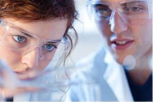 Two students doing a Chemistry lab