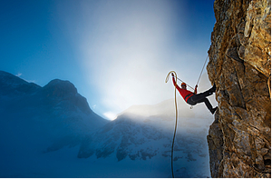 Mountain climber on a cliff with potential energy due to its position relative to the ground.