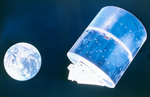 A picture of the earth from space and a cylindrical satellite next to it.